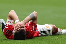 Bruno Fernandes of Manchester United lies injured during the Emirates FA Cup Semi Final match between Brighton & Hove Albion and Manchester United at Wembley Stadium on April 23, 2023 in London, England. (Photo by Matthew Peters/Manchester United via Getty Images)