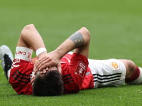 Bruno Fernandes of Manchester United lies injured during the Emirates FA Cup Semi Final match between Brighton & Hove Albion and Manchester United at Wembley Stadium on April 23, 2023 in London, England. (Photo by Matthew Peters/Manchester United via Getty Images)