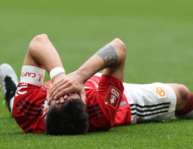 Bruno Fernandes of Manchester United lies injured during the Emirates FA Cup Semi Final match between Brighton & Hove Albion and Manchester United at Wembley Stadium on April 23, 2023 in London, England. (Photo by Matthew Peters/Manchester United via Getty Images)