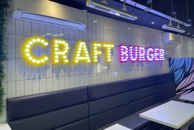 The venue is decorated with neon lighting and hand-painted murals.