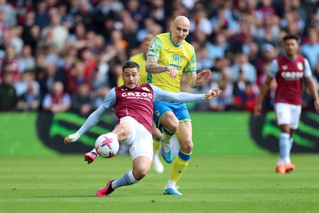 Emi Buendia of Aston Villa is challenged by Jonjo Shelvey of Nottingham Forest during the Premier League match between Aston Villa and Nottingham Forest at Villa Park on April 08, 2023 in Birmingham, England. (Photo by Nathan Stirk/Getty Images)