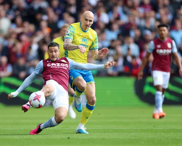 Emi Buendia of Aston Villa is challenged by Jonjo Shelvey of Nottingham Forest during the Premier League match between Aston Villa and Nottingham Forest at Villa Park on April 08, 2023 in Birmingham, England. (Photo by Nathan Stirk/Getty Images)