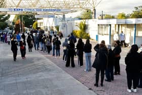 Cypriots wait in line to receive the third dose of a Covid-19 vaccine at a walk-in vaccination centre (Photo: Getty Images)