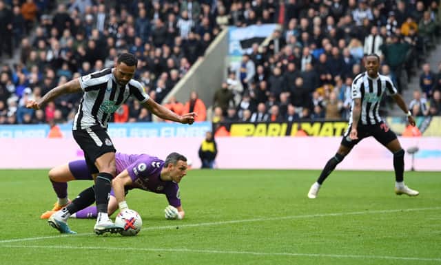 Newcastle striker Callum Wilson rounds Southampton goalkeeper Alex McCarthy to score the third goal during the Premier League match between Newcastle United and Southampton FC at St. James Park on April 30, 2023 in Newcastle upon Tyne, England. 