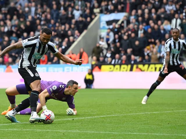 Newcastle striker Callum Wilson rounds Southampton goalkeeper Alex McCarthy to score the third goal during the Premier League match between Newcastle United and Southampton FC at St. James Park on April 30, 2023 in Newcastle upon Tyne, England. 