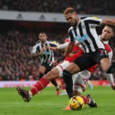 oelinton of Newcastle United shoots under pressure from William Saliba of Arsenal during the Premier League match between Arsenal FC and Newcastle United at Emirates Stadium on January 03, 2023 in London, England. (Photo by Justin Setterfield/Getty Images)