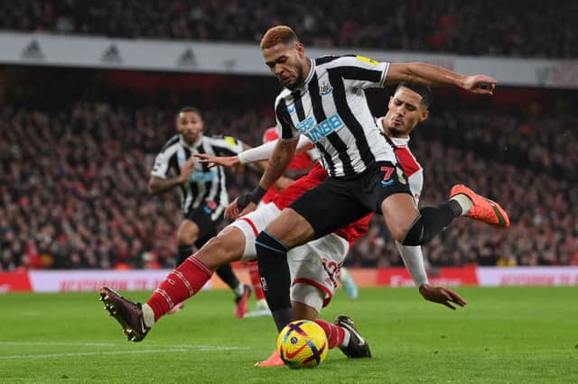 oelinton of Newcastle United shoots under pressure from William Saliba of Arsenal during the Premier League match between Arsenal FC and Newcastle United at Emirates Stadium on January 03, 2023 in London, England. (Photo by Justin Setterfield/Getty Images)
