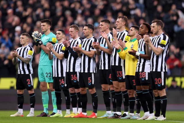 A general view of players of Newcastle United, as Bruno Guimaraes wears a signed Pele 10 shirt, as they hold a minutes applause in memory of former Brazil player Pele prior to the Premier League match between Newcastle United and Leeds United at St. James Park on December 31, 2022 in Newcastle upon Tyne, England. 