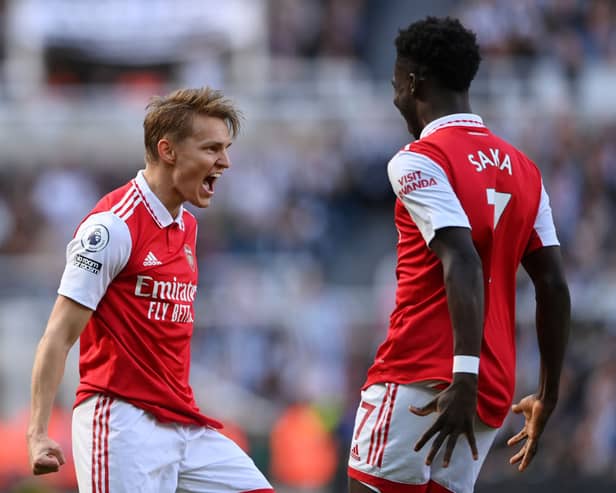  Martin Odegaard of Arsenal celebrates after scoring the team’s first goal with teammate Bukayo Saka during the Premier League match between Newcastle United and Arsenal FC at St. James Park on May 07, 2023 in Newcastle upon Tyne, England. (Photo by Stu Forster/Getty Images)