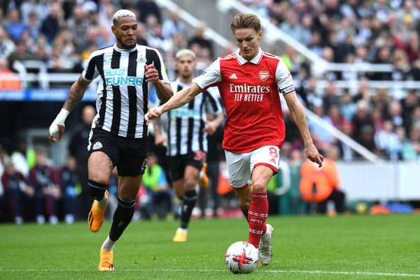 Martin Odegaard of Arsenal is challenged by Joelinton of Newcastle United during the Premier League match between Newcastle United and Arsenal FC at St. James Park on May 07, 2023 in Newcastle upon Tyne, England. (Photo by David Price/Arsenal FC via Getty Images)