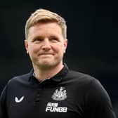 Newcastle manager Eddie Howe looks on and smiles during a match