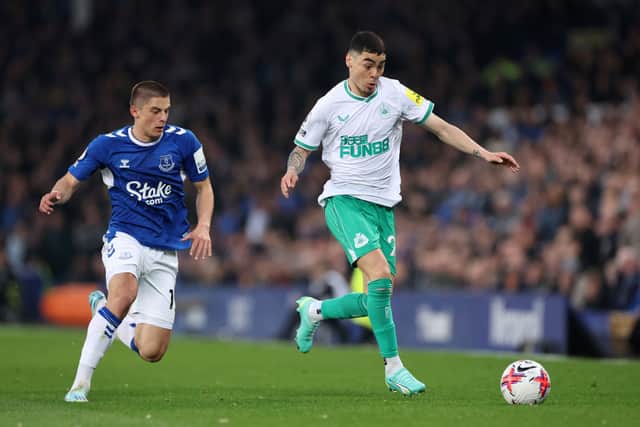 Miguel Almiron of Newcastle United runs with the ball whilst under pressure from Vitaliy Mykolenko of Everton during the Premier League match between Everton FC and Newcastle United at Goodison Park on April 27, 2023 in Liverpool, England.