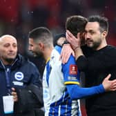 olly March is consoled Roberto De Zerbi, Manager of Brighton & Hove Albion, after the team's defeat in the penalty shoot out during the Emirates FA Cup Semi Final match between Brighton & Hove Albion and Manchester United at Wembley Stadium on April 23, 2023 in London, England. (Photo by Clive Rose/Getty Images)