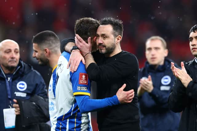 olly March is consoled Roberto De Zerbi, Manager of Brighton & Hove Albion, after the team's defeat in the penalty shoot out during the Emirates FA Cup Semi Final match between Brighton & Hove Albion and Manchester United at Wembley Stadium on April 23, 2023 in London, England. (Photo by Clive Rose/Getty Images)