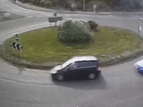 The moment a driver put their Need for Speed to the test as they drift around a busy roundabout.