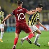 Fenerbahce's Turkish midfielder Arda Guler (R) vies for the ball with Sevilla's Croatian midfielder Ivan Rakitic (L) during the UEFA Europa League last 16 second leg football match between Fenerbahce SK and Sevilla FC at the Fenerbahce Ulker stadium in Istanbul on March 16, 2023. (Photo by OZAN KOSE / AFP) 