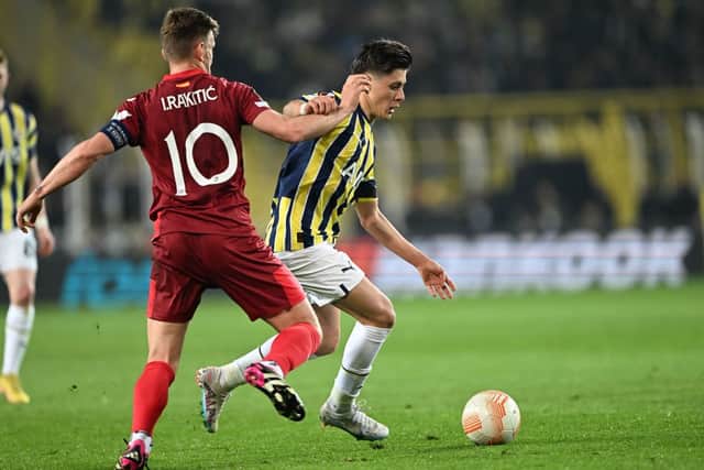 Fenerbahce's Turkish midfielder Arda Guler (R) vies for the ball with Sevilla's Croatian midfielder Ivan Rakitic (L) during the UEFA Europa League last 16 second leg football match between Fenerbahce SK and Sevilla FC at the Fenerbahce Ulker stadium in Istanbul on March 16, 2023. (Photo by OZAN KOSE / AFP)