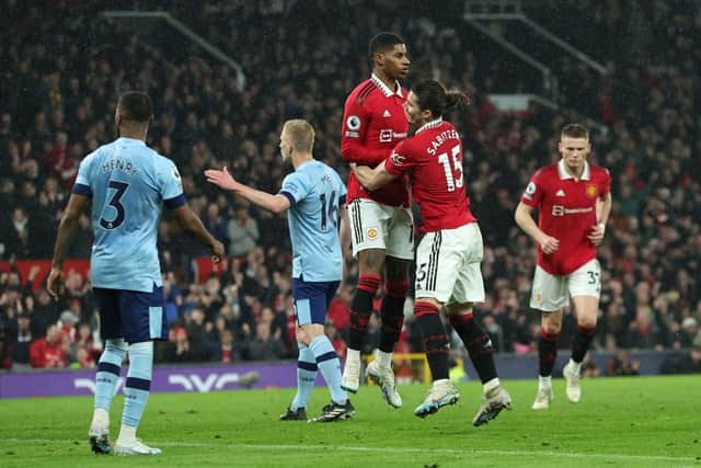 Marcus Rashford of Manchester United celebrates with teammate Marcel Sabitzer after scoring the team's first goal during the Premier League match between Manchester United and Brentford FC at Old Trafford on April 05, 2023 in Manchester, England. (Photo by David Rogers/Getty Images)