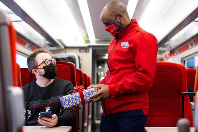 Titani Kamphandira, LNER Customer Experience Host (right), returns professionally wrapped presents (photo: David Parry/PA Wire)