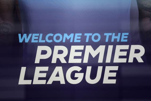 The logo is pictured through a glass window at the headquarters of the English Premier League in London on March 13, 2020.