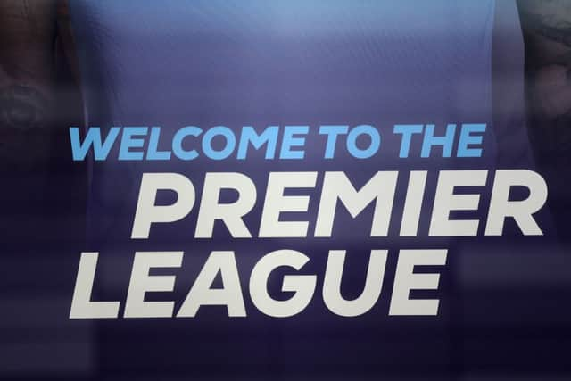 The logo is pictured through a glass window at the headquarters of the English Premier League in London on March 13, 2020. 