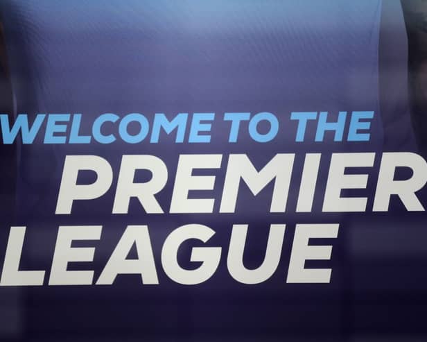 The logo is pictured through a glass window at the headquarters of the English Premier League in London on March 13, 2020. 