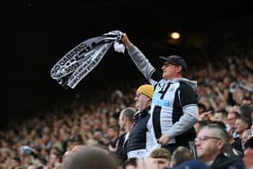 NEWCASTLE UPON TYNE, ENGLAND - MAY 18: Fans of Newcastle United celebrate their side's second goal scored by Dan Burn of Newcastle United (not pictured) during the Premier League match between Newcastle United and Brighton & Hove Albion at St. James Park on May 18, 2023 in Newcastle upon Tyne, England. (Photo by Stu Forster/Getty Images)