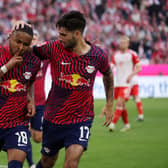 Christopher Nkunku of RB Leipzig celebrates with teammate Dominik Szoboszlai after scoring the team’s second goal during the Bundesliga match between FC Bayern Munchen and RB Leipzig at Allianz Arena on May 20, 2023 in Munich, Germany. 