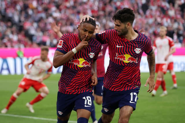 Christopher Nkunku of RB Leipzig celebrates with teammate Dominik Szoboszlai after scoring the team’s second goal during the Bundesliga match between FC Bayern Munchen and RB Leipzig at Allianz Arena on May 20, 2023 in Munich, Germany. 