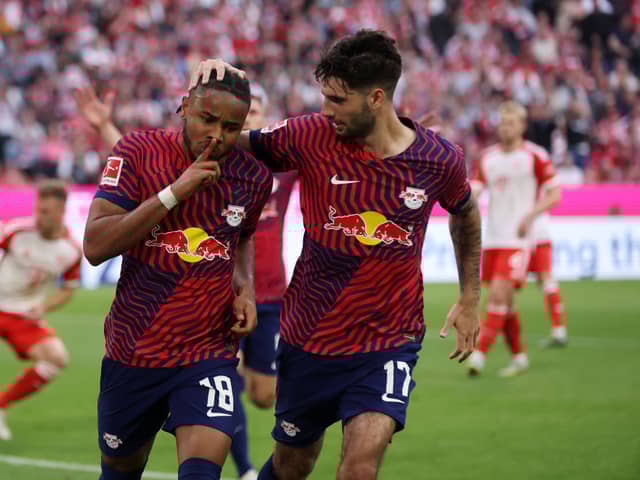 Christopher Nkunku of RB Leipzig celebrates with teammate Dominik Szoboszlai after scoring the team’s second goal during the Bundesliga match between FC Bayern Munchen and RB Leipzig at Allianz Arena on May 20, 2023 in Munich, Germany. 
