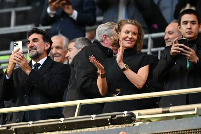 Newcastle United’s Saudi Arabian chairman Yasir Al-Rumayyan (L) and Newcastle United’s English minority owner Amanda Staveley (C) applaud the players ahead of the English League Cup final football match between Manchester United and Newcastle United at Wembley Stadium, north-west London on February 26, 2023. 