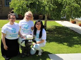 Members of the St Oswald's Hospice team with the small Shaun sculpture.