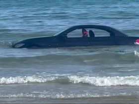 A convertable BMW was washed out to see after parking on a beach in Cornwall