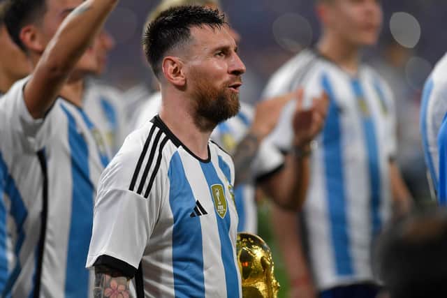 Lionel Messi of Argentina celebrates with the FIFA World Cup trophy on March 28, 2023 in Santiago del Estero, Argentina. (Photo by Hernan Cortez/Getty Images)