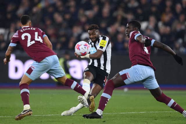 Allan Saint-Maximin of Newcastle United shoots under pressure from Thilo Kehrer of West Ham United and Kurt Zouma of West Ham United  during the Premier League match between West Ham United and Newcastle United at London Stadium on April 05, 2023 in London, England. 