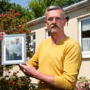 Leigh Blanning with a photo of his late father, John.