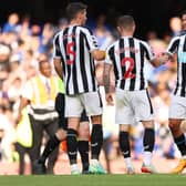 Bruno Guimaraes of Newcastle United embraces teammates after the draw during the Premier League match between Chelsea FC and Newcastle United at Stamford Bridge on May 28, 2023 in London, England. 
