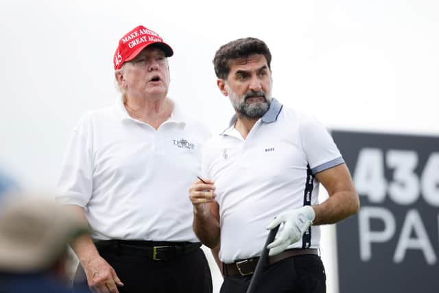 U.S. President Donald Trump and Yasir al-Rumayyan, head of the sovereign wealth fund of Saudi Arabia, look on from the second tee during the pro-am prior to the LIV Golf Invitational - Bedminster at Trump National Golf Club Bedminster on July 28, 2022 in Bedminster, New Jersey. (Photo by Cliff Hawkins/Getty Images)