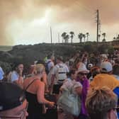 Tourists are evacuated from hotels during a wildfire on the Greek island of Rhodes on July 22, 2023.