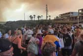 Tourists are evacuated from hotels during a wildfire on the Greek island of Rhodes on July 22, 2023.
