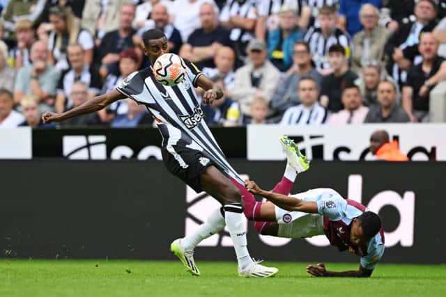 Alexander Isak of Newcastle United is challenged by Ezri Konsa of Aston Villa during the Premier League match between Newcastle United and Aston Villa at St. James Park on August 12, 2023 in Newcastle upon Tyne, England. 