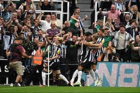 Sandro Tonali of Newcastle United celebrates with team mates and fans after scoring the opening goal (Photo by Stu Forster/Getty Images)