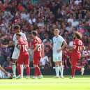  Referee Thomas Bramall shows a red card to Alexis Mac Allister of Liverpool following a challenge on Ryan Christie of AFC Bournemouth (on floor) during the Premier League match between Liverpool FC and AFC Bournemouth at Anfield on August 19, 2023 in Liverpool, England. (Photo by George Wood/Getty Images)