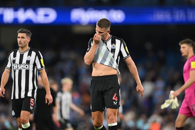 Newcastle players Fabian Schar (l) Sven Botman (c) and Nick Pope react dejectedly after the Premier League match between Manchester City and Newcastle United at Etihad Stadium on August 19, 2023 in Manchester, England. (Photo by Stu Forster/Getty Images)