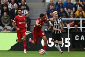Anthony Gordon of Newcastle United vies with Trent Alexander-Arnold of Liverpool during the Premier League match between Newcastle United and Liverpool FC at St. James Park on August 27, 2023 in Newcastle upon Tyne, England. (Photo by Ian MacNicol/Getty Images)
