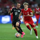 Bobby Clark of Liverpool controls the ball under pressure from Arijon Ibrahimovic of Bayern Muenchen during the pre-season friendly match between Liverpool and Bayern Muenchen at the National Stadium on August 02, 2023 in Singapore. (Photo by Lionel Ng/Getty Images)