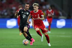 Bobby Clark of Liverpool controls the ball under pressure from Arijon Ibrahimovic of Bayern Muenchen during the pre-season friendly match between Liverpool and Bayern Muenchen at the National Stadium on August 02, 2023 in Singapore. (Photo by Lionel Ng/Getty Images)