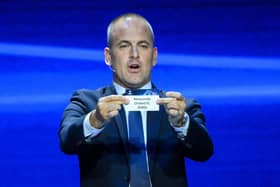 English former football player Joe Cole shows the paper slip of Newcastle United FC during the draw for the 2023/2024 UEFA Champions League football tournament at The Grimaldi Forum in the Principality of Monaco, on August 31, 2023. (Photo by NICOLAS TUCAT / AFP) (Photo by NICOLAS TUCAT/AFP via Getty Images)