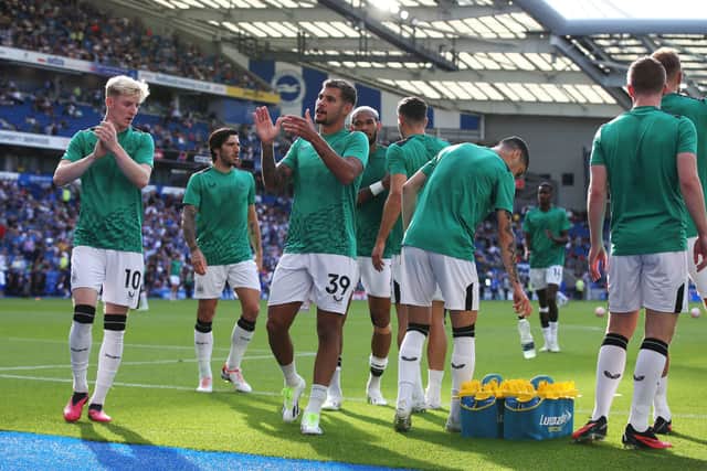 Newcastle United players applauds the fans as they warm up prior to the Premier League match between Brighton & Hove Albion and Newcastle United at American Express Community Stadium on September 02, 2023 in Brighton, England. 