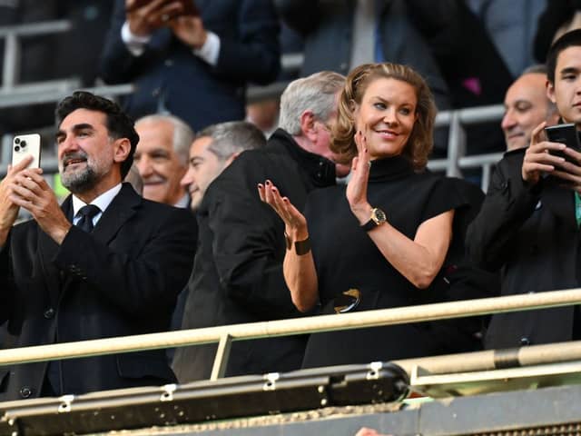 Newcastle United's Saudi Arabian chairman Yasir Al-Rumayyan (L) and Newcastle United's English minority owner Amanda Staveley (C) applaud the players ahead of the English League Cup final football match between Manchester United and Newcastle United at Wembley Stadium, north-west London on February 26, 2023. (Photo by Glyn KIRK / AFP) 